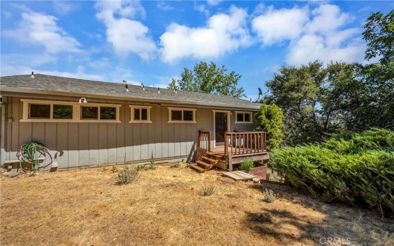 back yard , small deck and door to primary bedroom