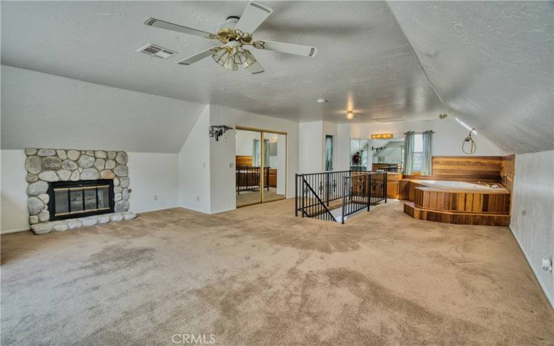 primary suite has stone hearth fireplace