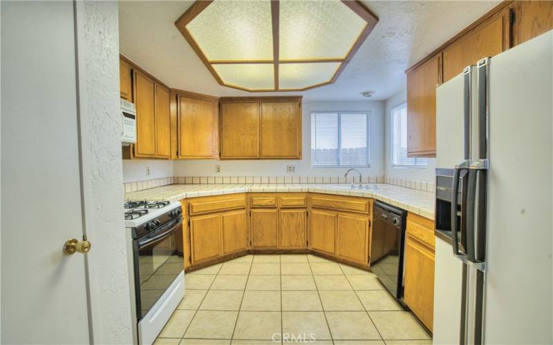 kitchen with tile flooring and oak cabinets