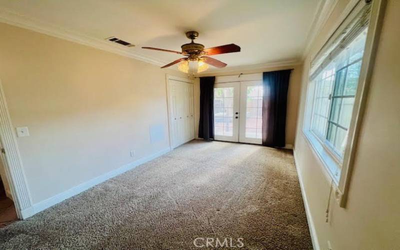 Bedroom showing french doors to the backyard and closet.