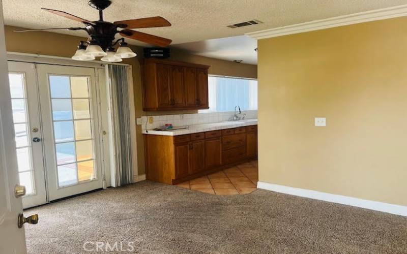 Dining area showing side entrance and kitchen.