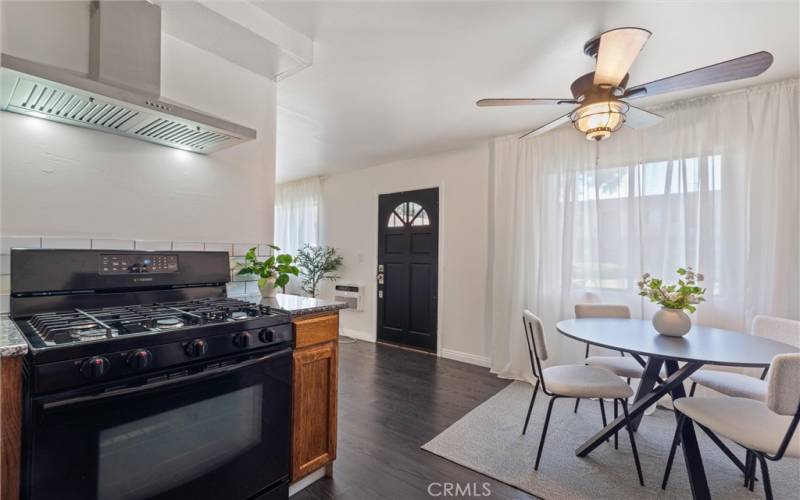 Kitchen area with gas stove new hood