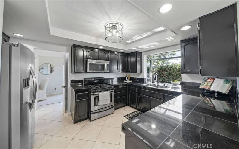 Sleek Black Marble Countertops. After these photos were taken the sellers replace this stove with a brand new 5 Burner State of the Art Stainless Range!