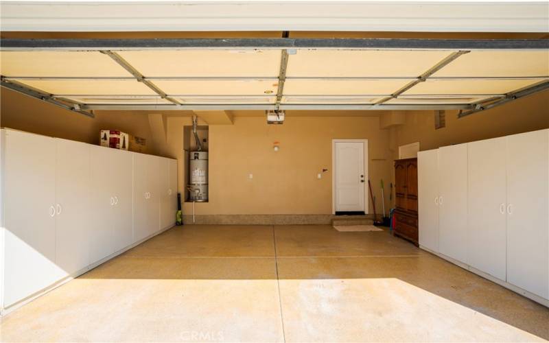 Apoxy Garage Floors with Included White Cabinets for Storage