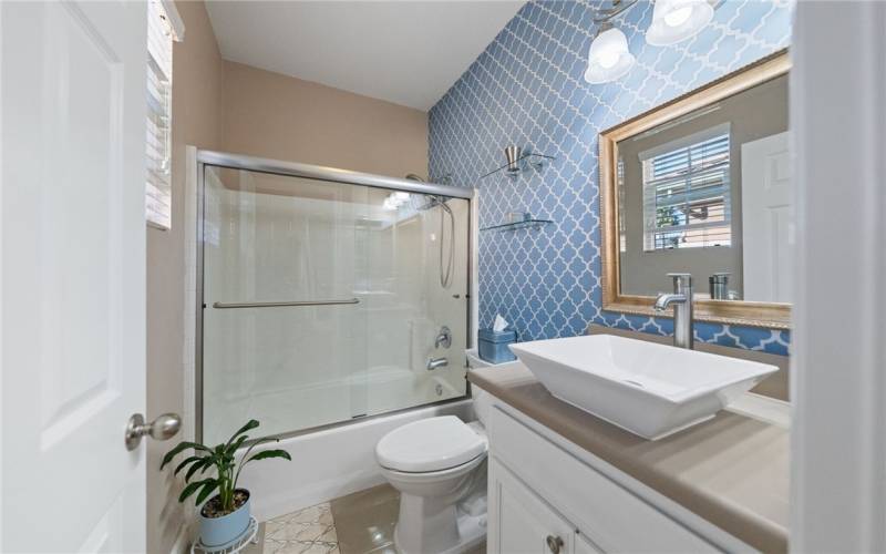 Main floor bath with tub-shower just off of the main floor bedroom