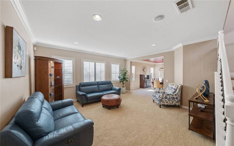 Living room with recessed lighting and plantation shutters