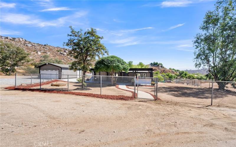 2-car garage, storage shed, and fenced yard