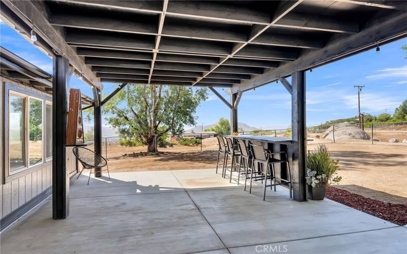 expansive covered patio with a built-in bar top counter