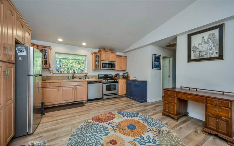 Open kitchen with stainless steel appliances.