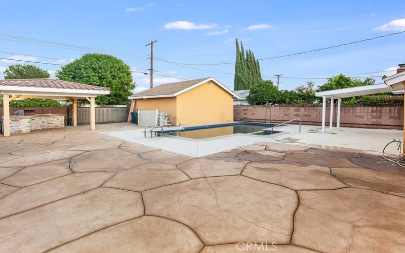 The private backyard will be a favorite entertainment destination with its sparkling in-ground pool and spa, expansive covered patio, custom built and fully covered BBQ island with granite countertops, stainless steel basin and refrigerator; plus, handy alley access for additional vehicle parking.