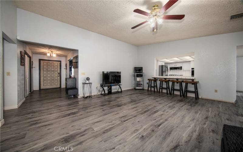 Great Room looking south. Front Door is to the left and Kitchen Breakfast Bar to the right.