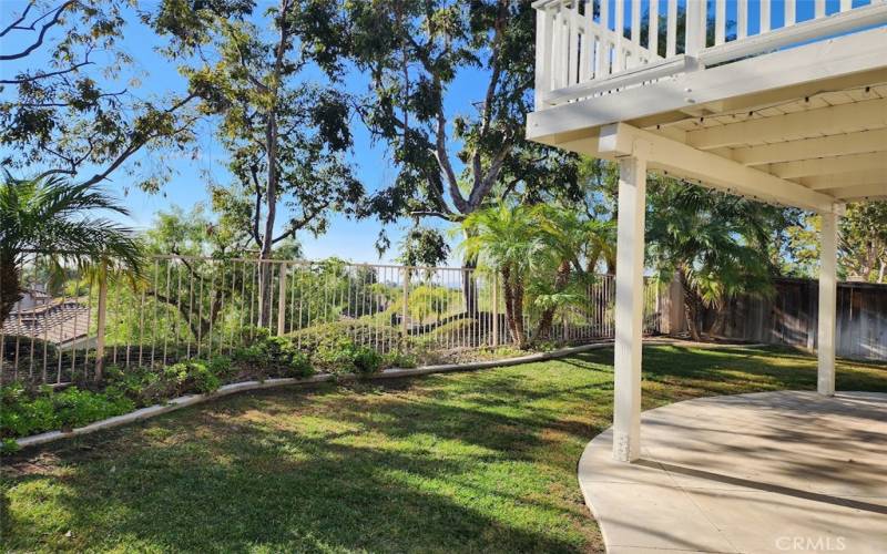 Inviting backyard with plenty of grass and covered patio. Peek-a-boo sunset views from upstairs