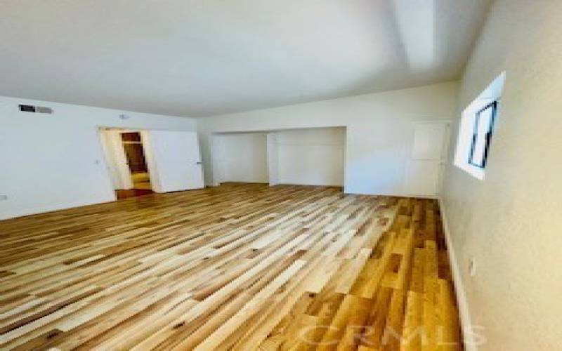 Primary Bedroom  has NEW Flooring, tall ceilings.