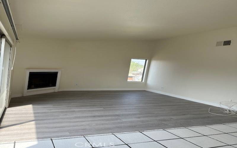 Living Room with a fireplace and brand new laminate flooring