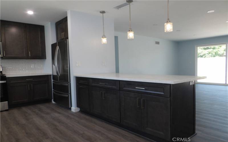 Peninsula counter with quartz counter and remodeled cabinets