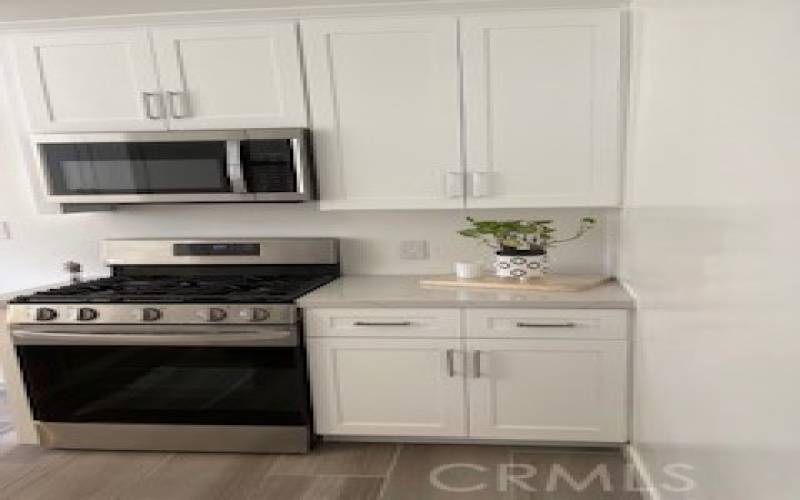 Kitchen Stainless Steel Stove and Microwave/ Cabinets and Quartz countertop