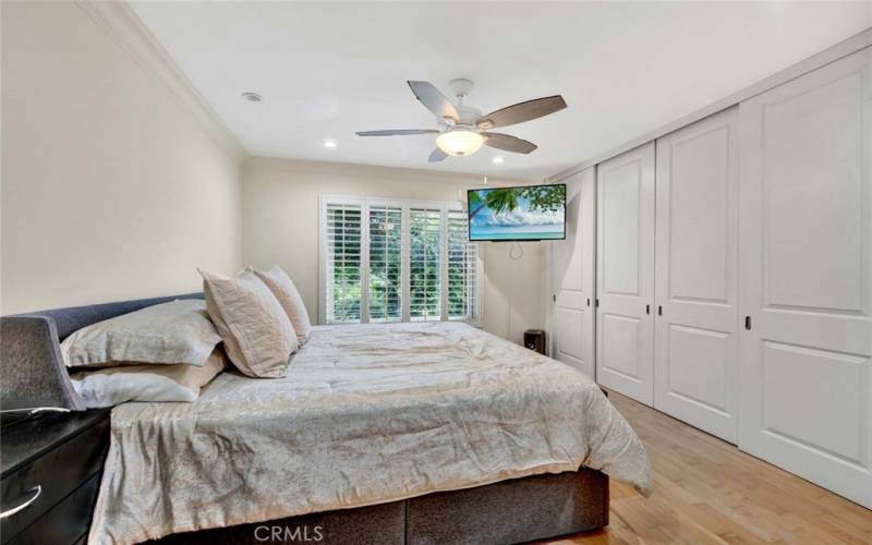 Primary Suite with Wall-to-Wall Closets, Dual Pane Window, Plantation Shutters, and Ceiling Fan