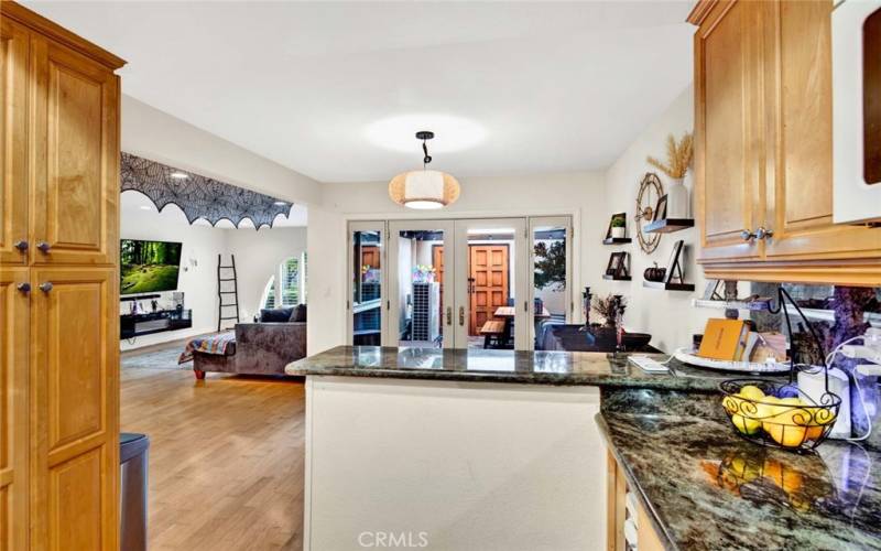 From Kitchen Looking out to Dining Room, Living Room and French Doors to Private Patio