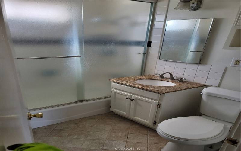 Fine tile work on bathroom wall and floor.