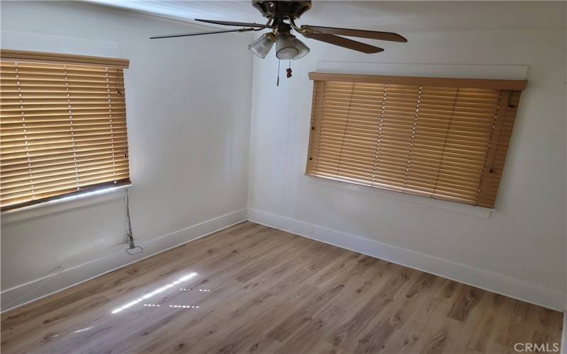 Bedroom 3 windows and matching quality flooring.