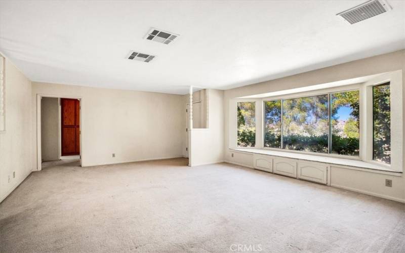 Huge picture windows in the living room capturing nature and views.