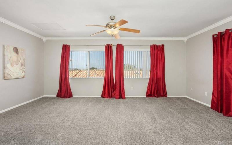 Large master suite with view of surrounding hills.