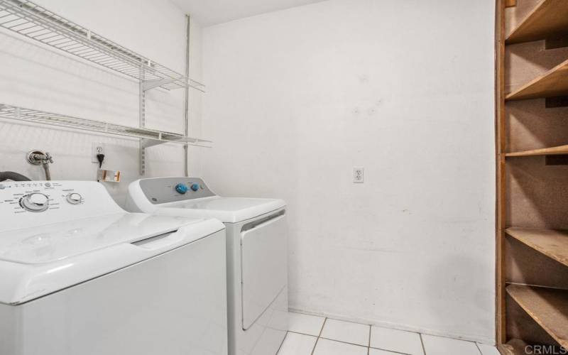 Upstairs laundry room comes with new dryer & newer washing machine. Storage cabinets & shelv8es.