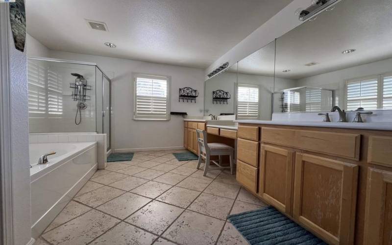 With tub and shower, and his and hers sinks.