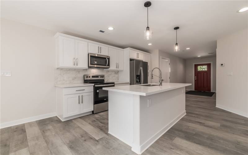 Kitchen area and entry hallway.