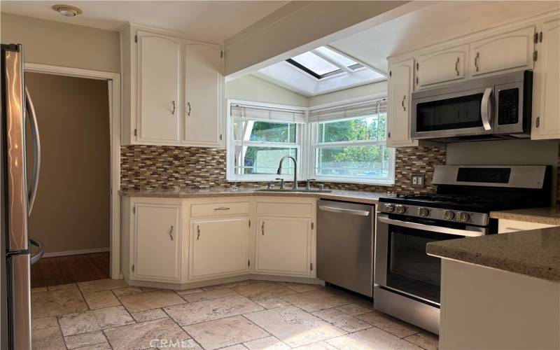 Kitchen with skylight and stainless appliances