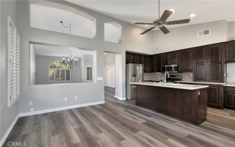 View of family room and kitchen, shows breakfast bar