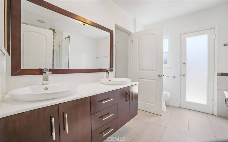 Primary bathroom with door to side yard. Tub and walk in shower not in the picture.