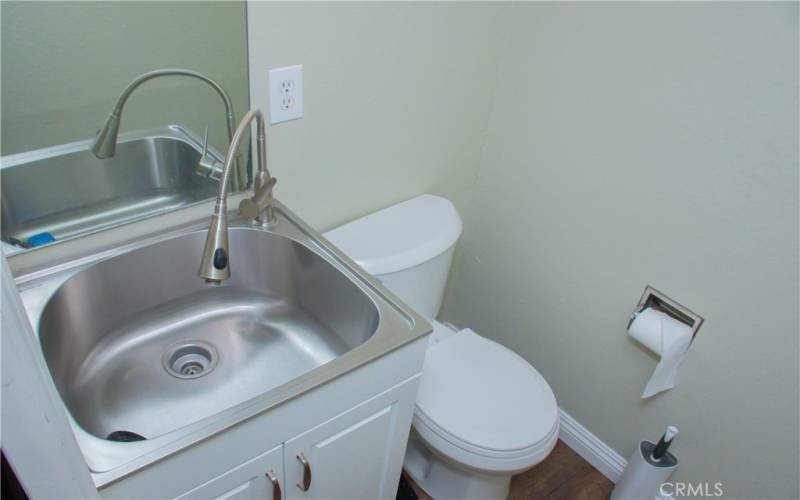 1/2 bath located next to laundry area and kitchen.