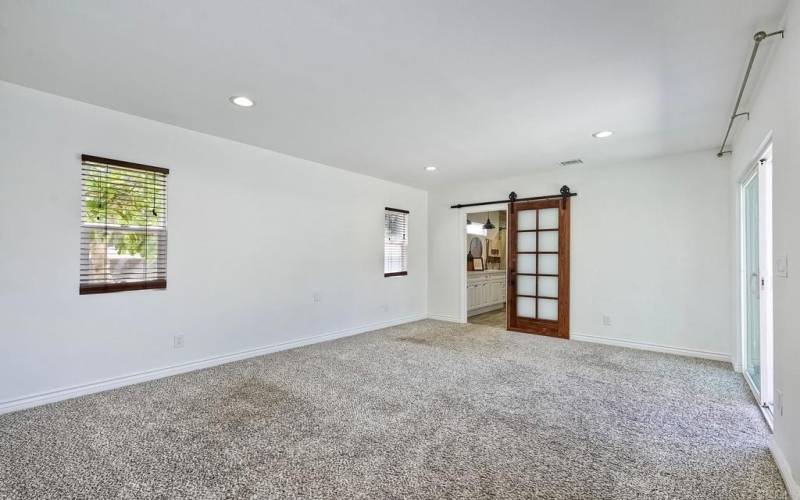 Barn door creates primary bath privacy~