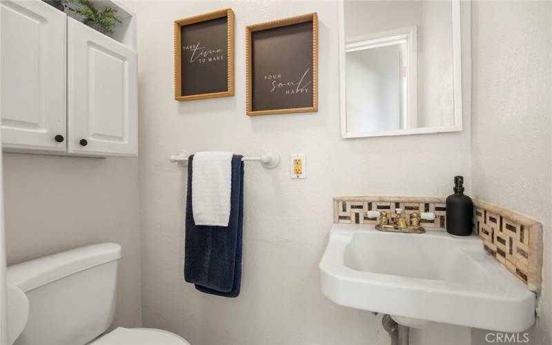 The powder room is conveniently located between the kitchen and dining area.