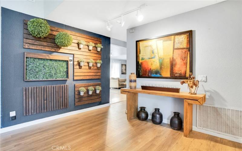 Double doors sweep open to a dramatic entryway with a chic accent wall that leads to a bright and flowing open concept floor plan.