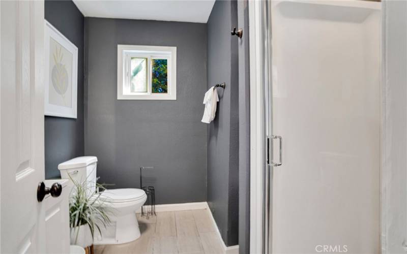 2 downstairs junior primary suites with sparkling windows, lighted ceiling fans, private entries (one offers access to the backyard); plus, private en suite bathrooms with white vanities, undermount basins, touch screen back-lit mirrors and tile floors.