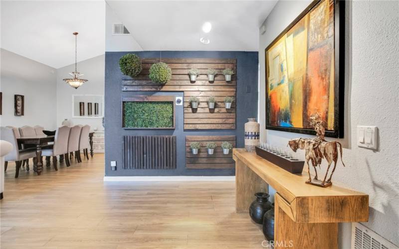 Double doors sweep open to a dramatic entryway with a chic accent wall that leads to a bright and flowing open concept floor plan.