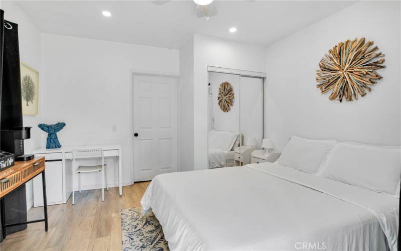 2 downstairs junior primary suites with sparkling windows, lighted ceiling fans, private entries (one offers access to the backyard); plus, private en suite bathrooms with white vanities, undermount basins, touch screen back-lit mirrors and tile floors.