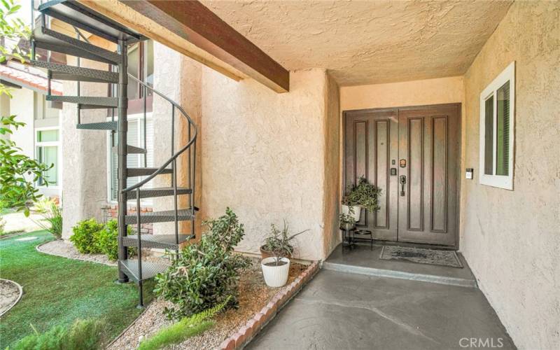 Double doors sweep open to a dramatic entryway with a chic accent wall that leads to a bright and flowing open concept floor plan.