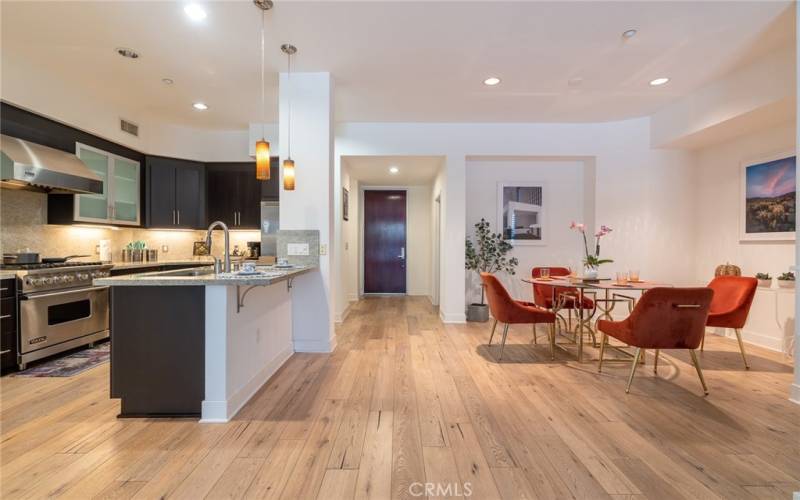 a view of kitchen, main entry, and dinning area