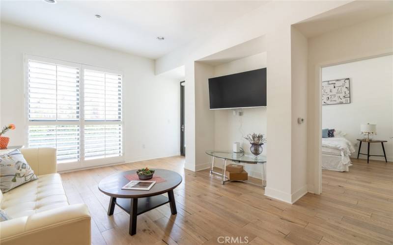 a view of living room and a master room is behind the TV wall