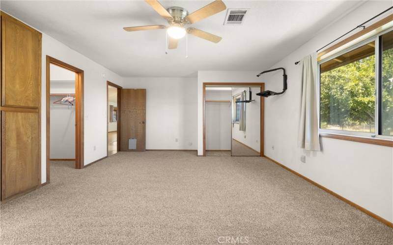 Main Primary Bedroom with walk-in closet to the left, regular closet, then storage to the very far left.