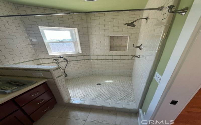 Large walk in shower in primary bathroom.