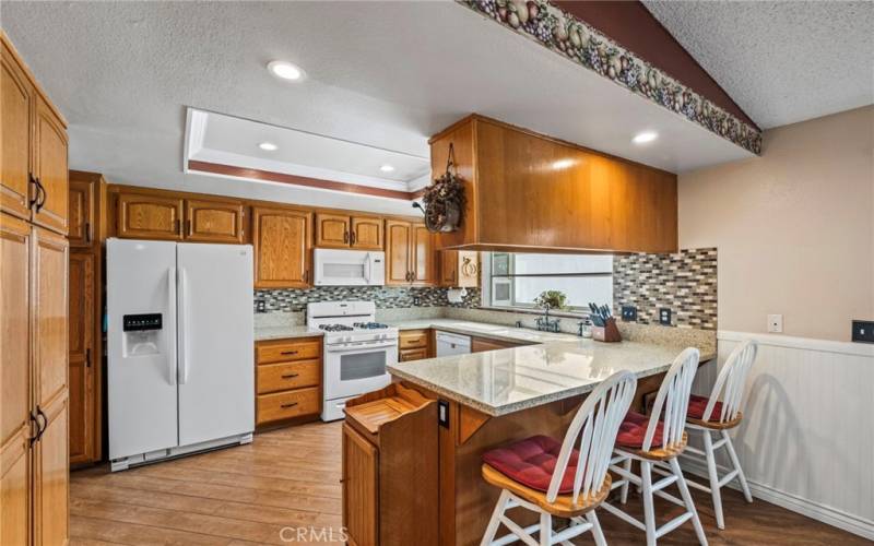 Kitchen with breakfast bar. Refrigerator stays