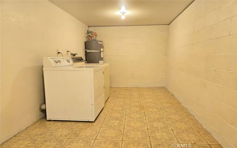 Laundry & storage room adjacent to garage