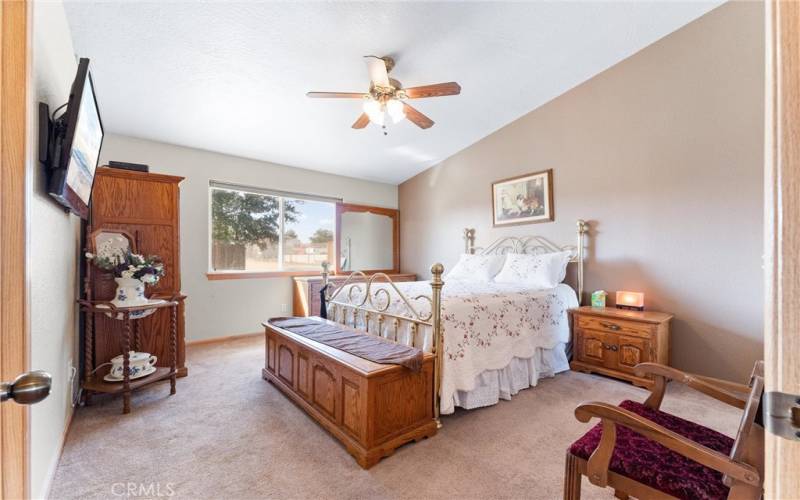 Primary bedroom with a walk in closet