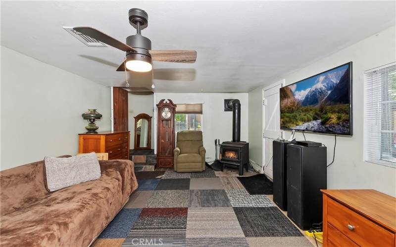 Unpermitted bonus room with its own wood burner that could be used as bedroom 3 or as a second family/game room.