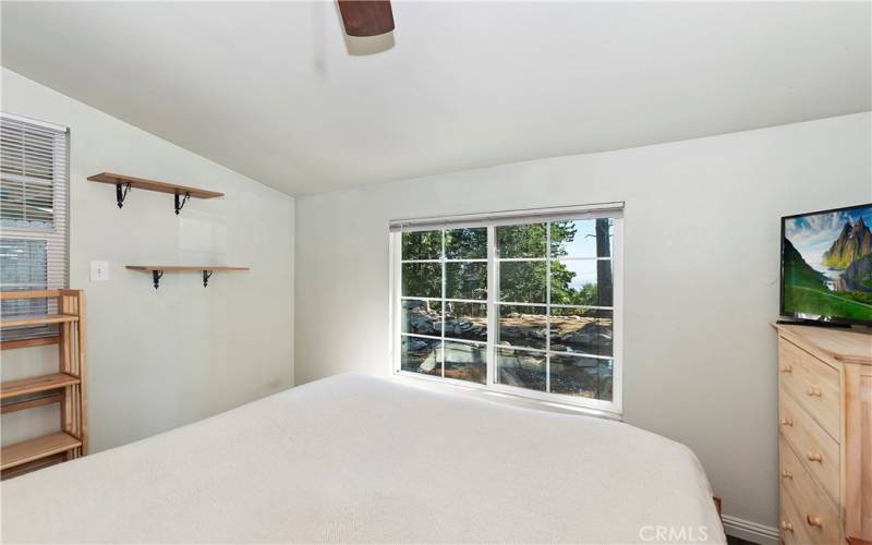 Bedroom 1 with view of the pond and peak-a-boo of the city.