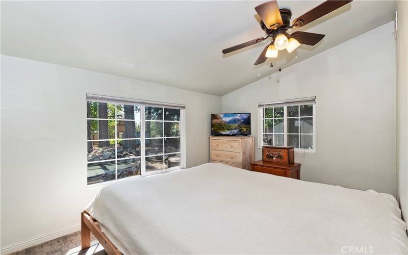 Bedroom 1 with view of the pond and peak-a-boo of the city.